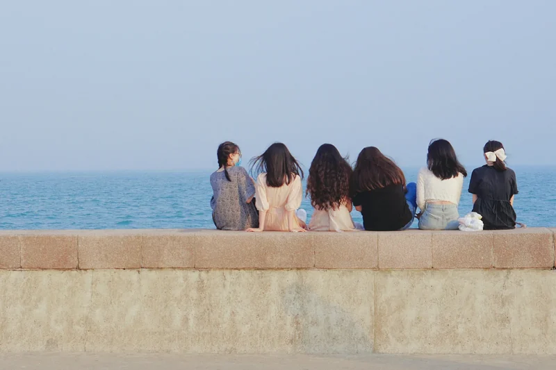 A group sitting together by the sea