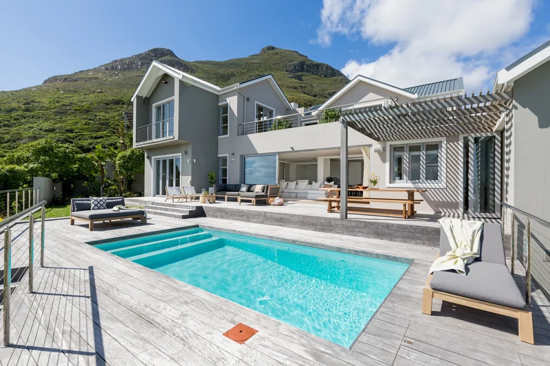 The house and pool terrace beneath the Noordhoek mountains