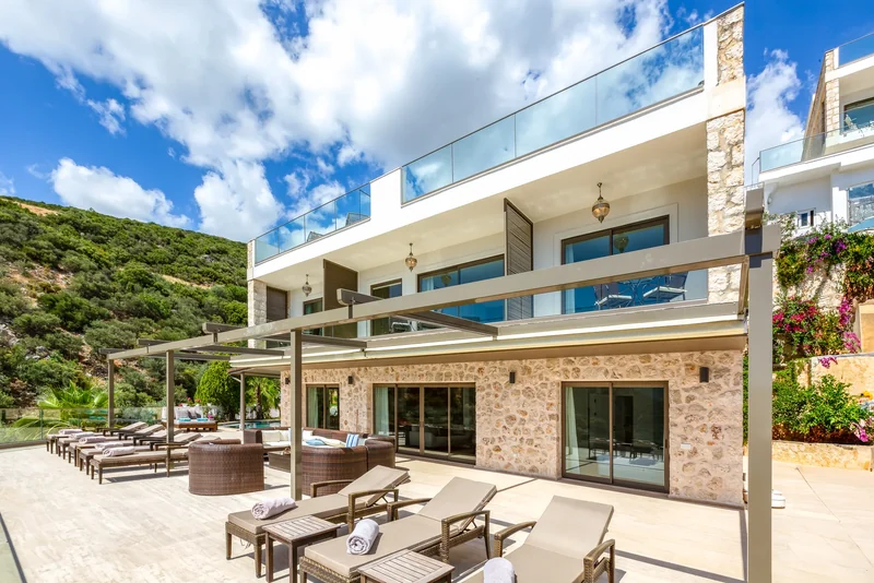 A house in Kalkan with broad balconies and a shaded pool terrace
